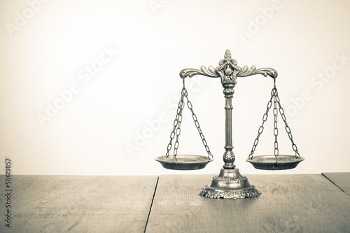 Law scales on table. Symbol of justice. Sepia photo