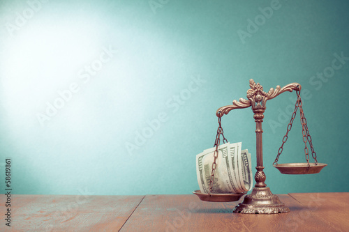 Law scales and cash money on table concept photo