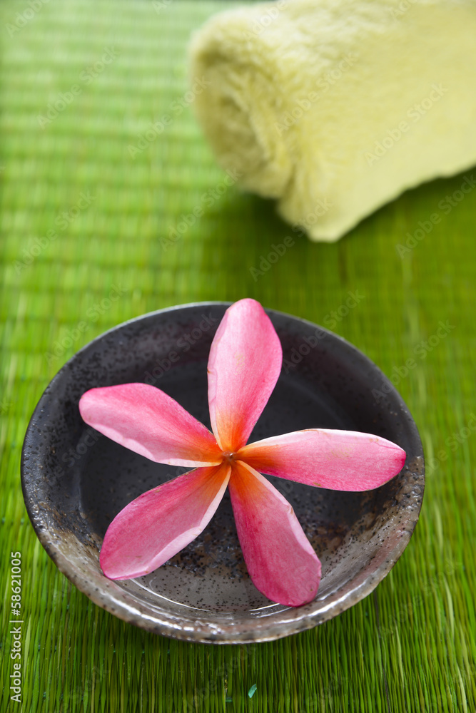 frangipani flower in wooden bowl on straw mat frangipani flower in wooden bowl on straw mat