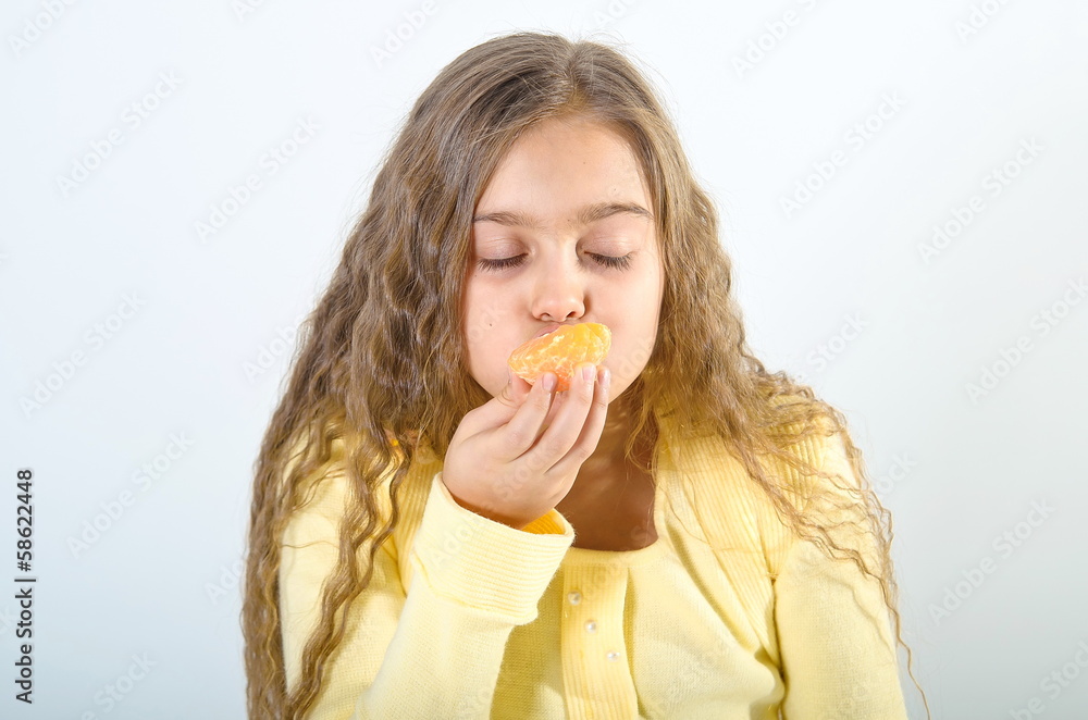 girl eats an orange