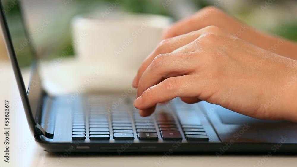 Hands typing on a laptop keyboard Hands typing on a laptop keyboard