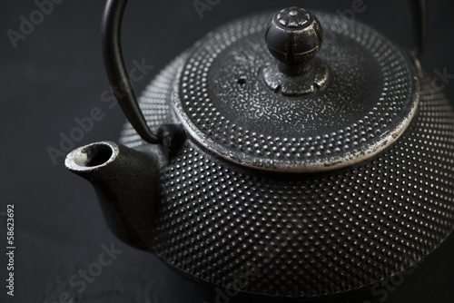 Horizontal shot of black asian cast-iron teapot, close-up