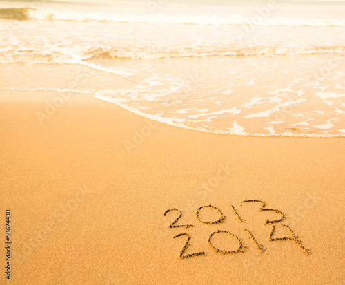 2013 - 2014 written in sand on beach texture