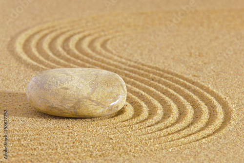 Japanese ZEN garden with stone in raked sand photo