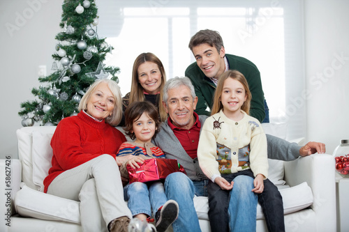 Family With Christmas Present In House