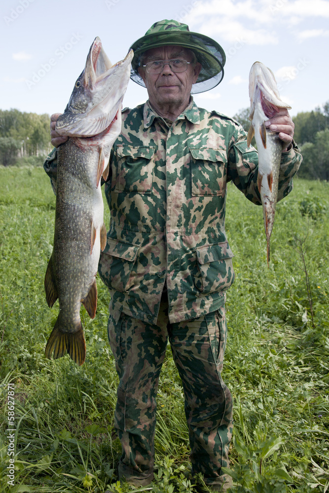 Naklejka premium A fisherman caught a pike