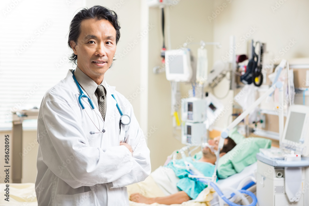 Confident Doctor With Patient Resting In Hospital Confident Doctor With Patient Resting In Hospital