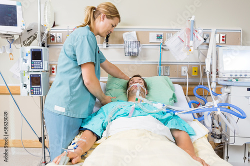 Nurse Adjusting Patient's Pillow