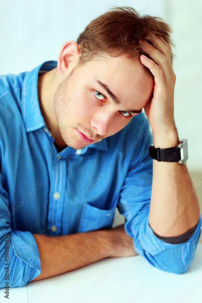 Portrait of a young businessman in blue shirt at office Portrait of a young businessman in blue shirt at office