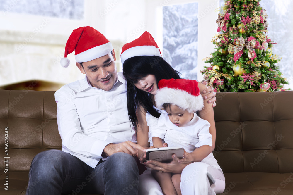Christmas family play with a tablet Christmas family play with a tablet