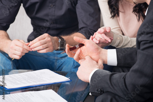 Фотография people signing a document