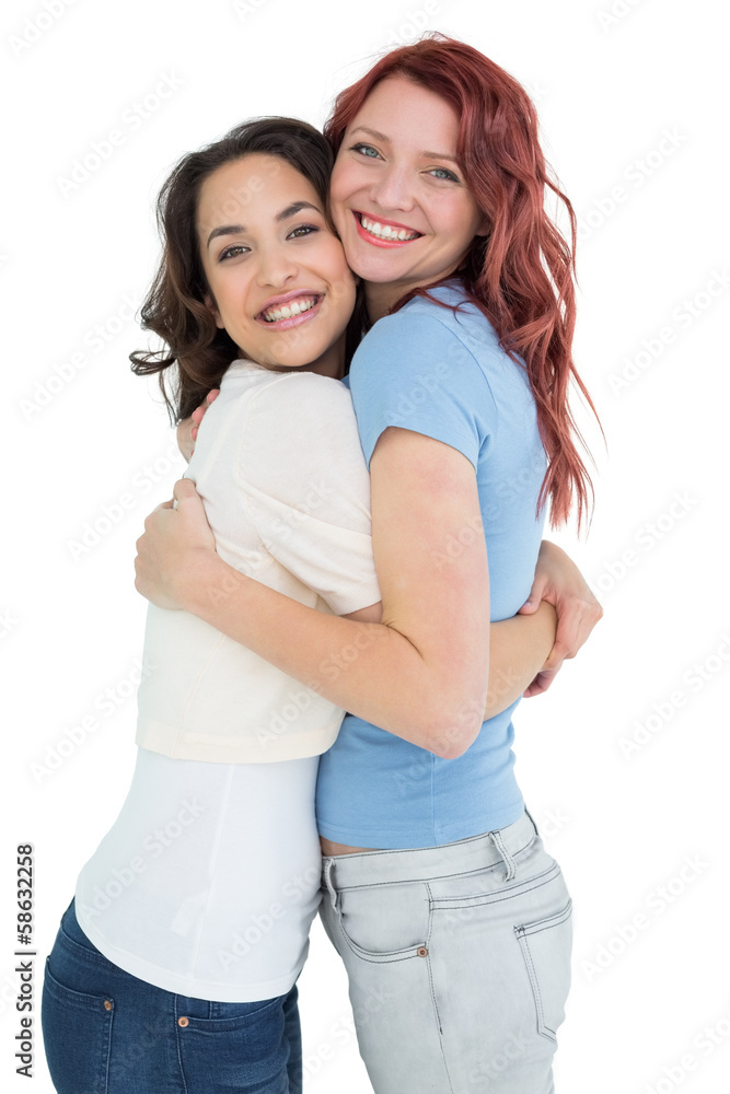 Side view portrait of a young female embracing her friend Side view portrait of a young female embracing her friend