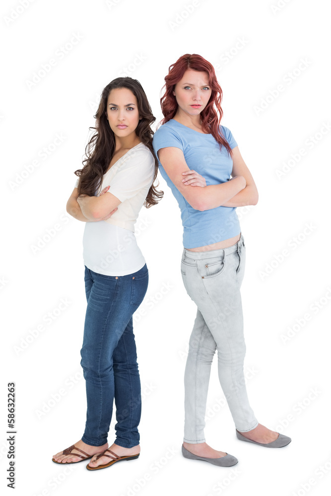 Portrait of two female friends with arms crossed Portrait of two female friends with arms crossed