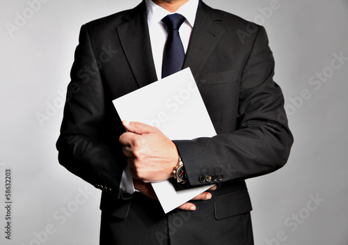 Bisnessman holds a booklet
