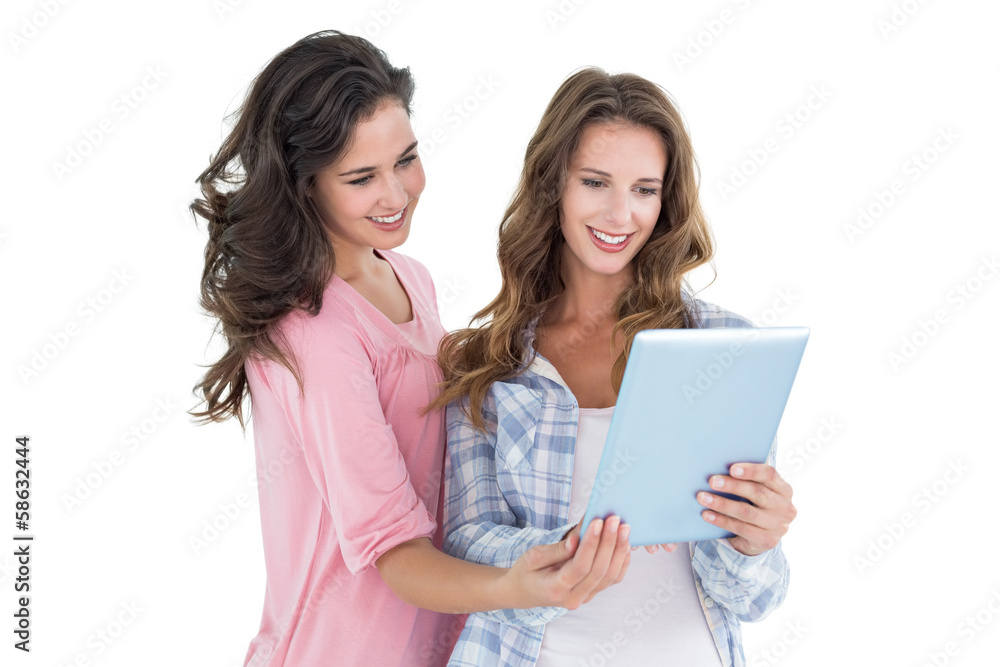 Two casual young female friends with digital tablet Two casual young female friends with digital tablet