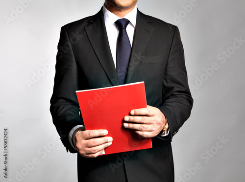 Bisnessman holds a booklet photo