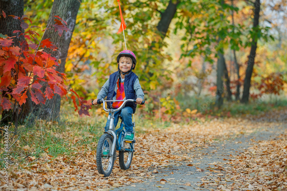 Fototapeta premium Little boy on bicycle
