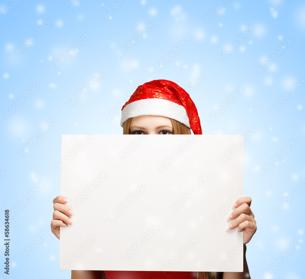 Young woman in santa claus hat with christmas greeting card Young woman in santa claus hat with christmas greeting card