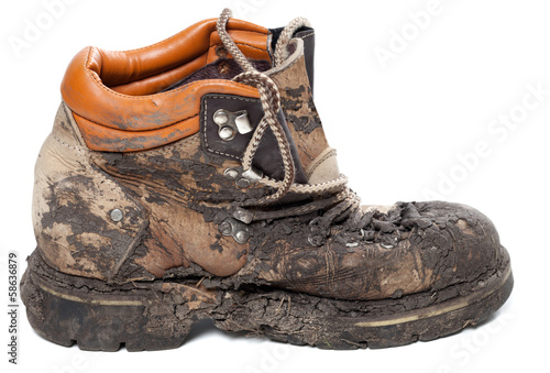 Old dirty trekking boot. Side view. photo