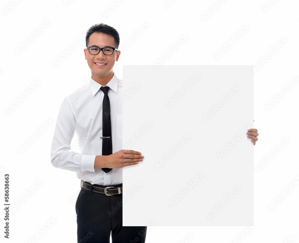 Young businessman holding blank billboard Young businessman holding blank billboard