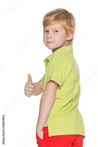Red-haired young boy with his thumb up