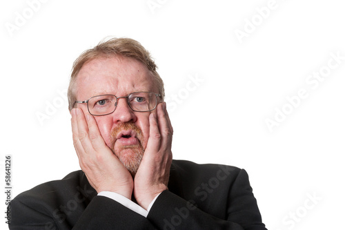 Shocked middle aged man in tuxedo on white