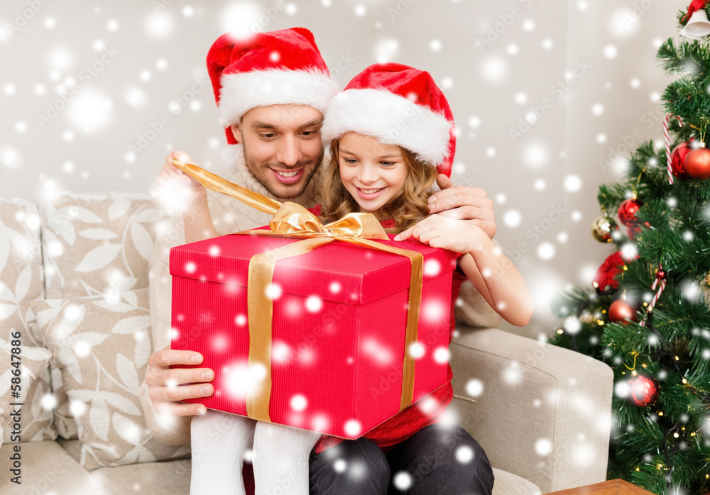 smiling father and daughter opening gift box