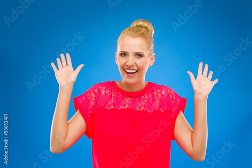 Portrait of a happy woman with hands up. © studioloco