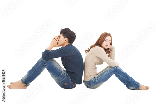 young Couple sitting back to back during conflict