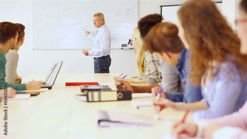 Teacher in classroom giving math presentation Teacher in classroom giving math presentation