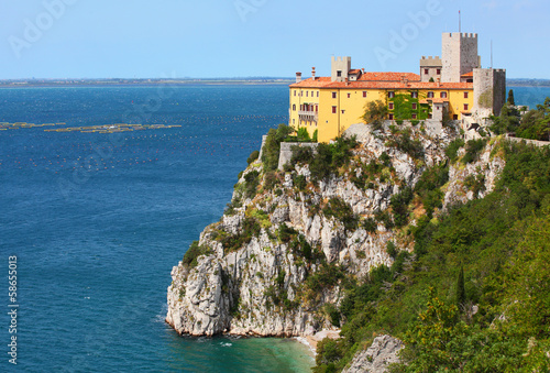 Gothic Duino castle on a cliff over the Gulf of Trieste , Italy.