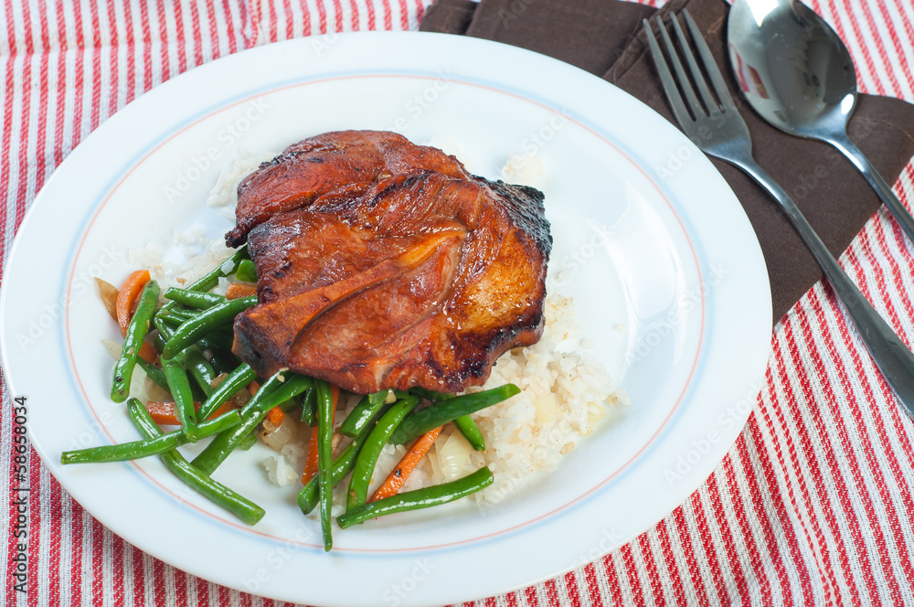 pork barbecue steak with french beans and carrots on garlic rice pork barbecue steak with french beans and carrots on garlic rice