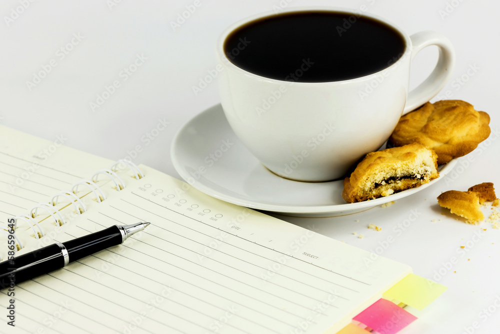 cup of coffee,cookies,notebook and pen isolated on white backgro cup of coffee,cookies,notebook and pen isolated on white backgro
