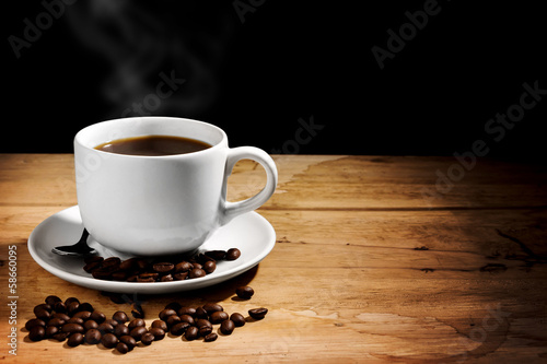 coffee cup on wooden table,dark background,still life photograph