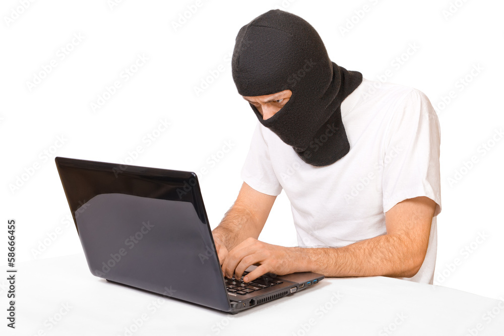 Man in black mask looking at monitor Man in black mask looking at monitor