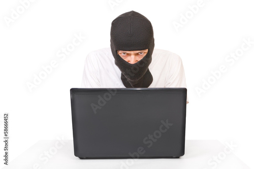 Man in black mask with computer looking at camera