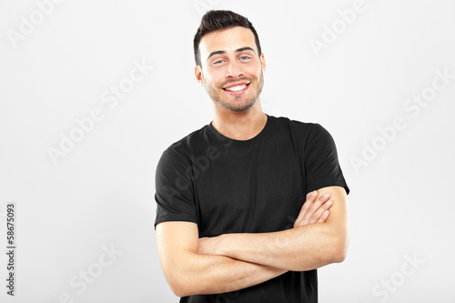 Smiling guy with crossed arms photo