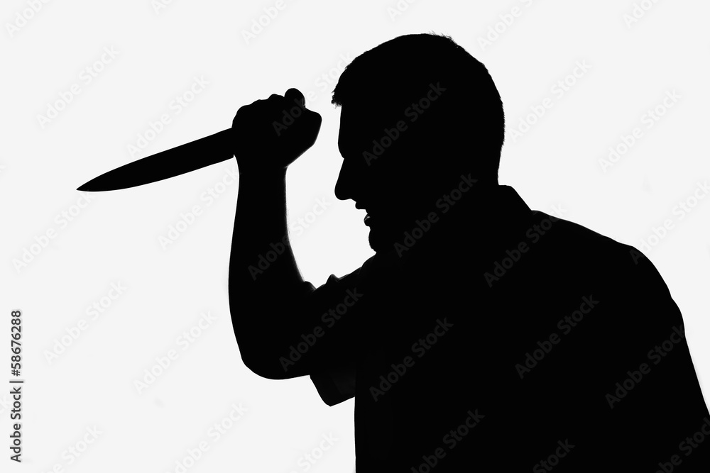 Killer man holding knife in hand. Silhouette picture Killer man holding knife in hand. Silhouette picture