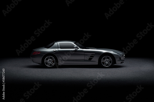 Side view of luxury sports car over black background