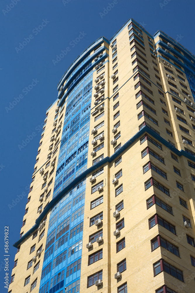 High modern multi-storey building building over blue sky High modern multi-storey building building over blue sky