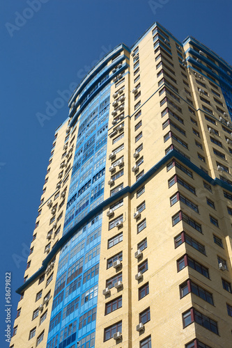 High modern multi-storey building building over blue sky