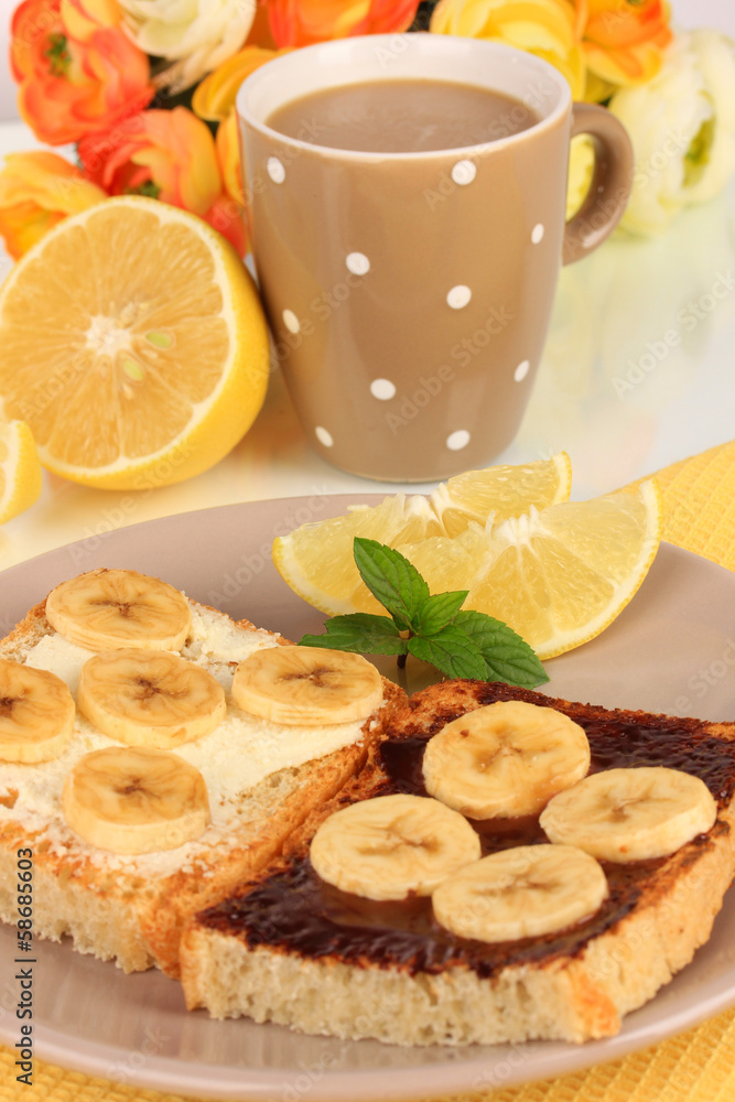 Delicious toast with bananas on plate close-up