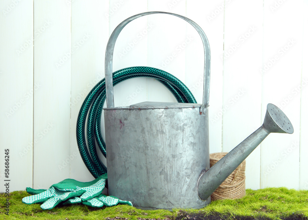 Gardening tools on grass on wooden background Gardening tools on grass on wooden background