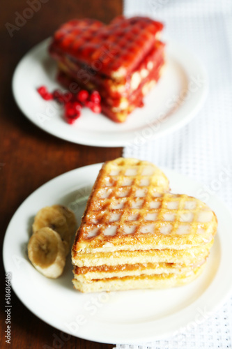 Sweet waffles on plates. on wooden background