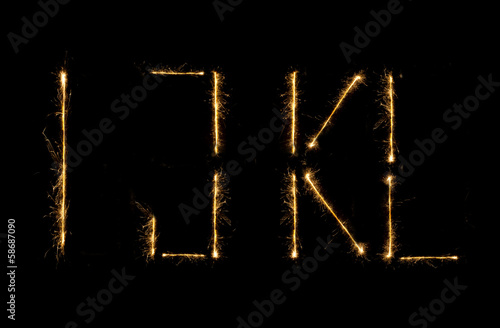 Shiny alphabet isolated on black photo