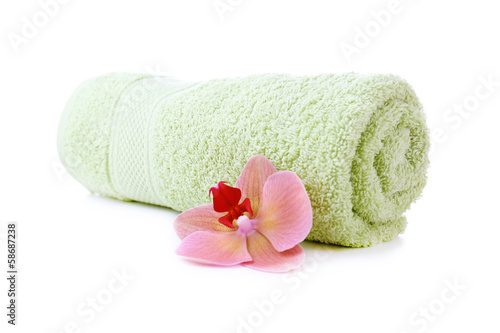 Orchid flower and towel roll, isolated on white