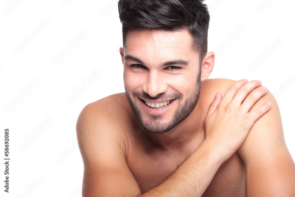 smiling naked man with hand on his shoulder smiling naked man with hand on his shoulder