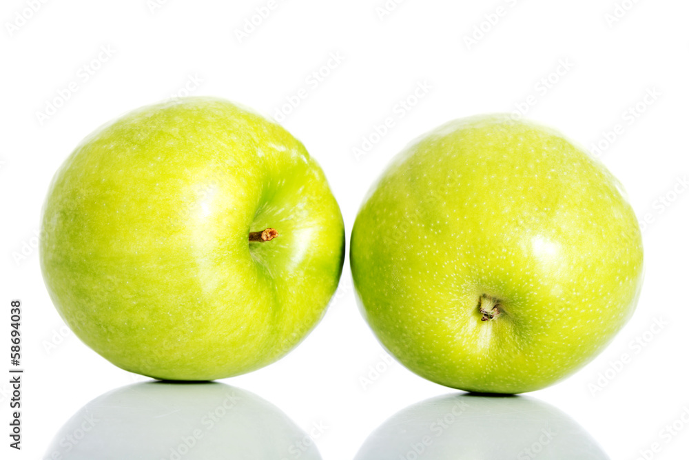 Two green apples over white. Two green apples over white.