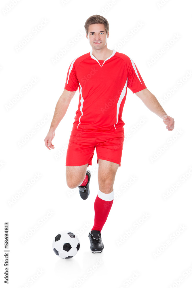 Soccer Player Kicking Football