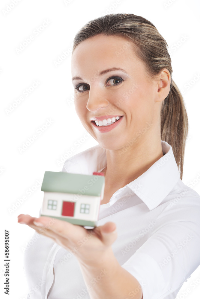 Young business woman holding a house on hand. Young business woman holding a house on hand.